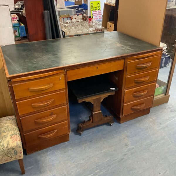 Vintage mid-century pedestal desk with leather top and eight drawers.