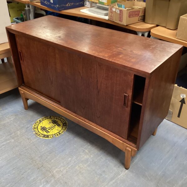 Vintage mid-century teak sideboard cabinet with sliding doors.