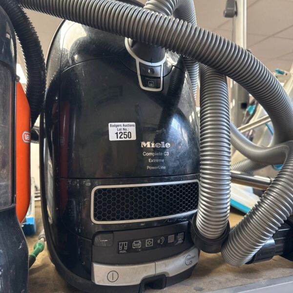 Miele C3 Extreme Powerline vacuum cleaner with hose attached.