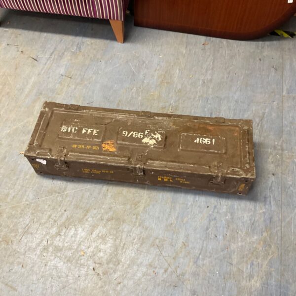 Vintage military ammunition box marked UN-SFR-NP, showing wear.