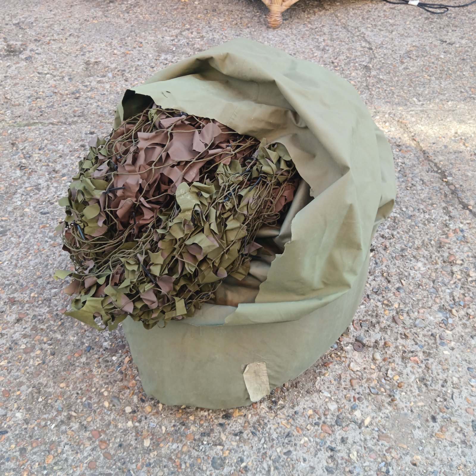 Large bag of used military camo netting for concealment.