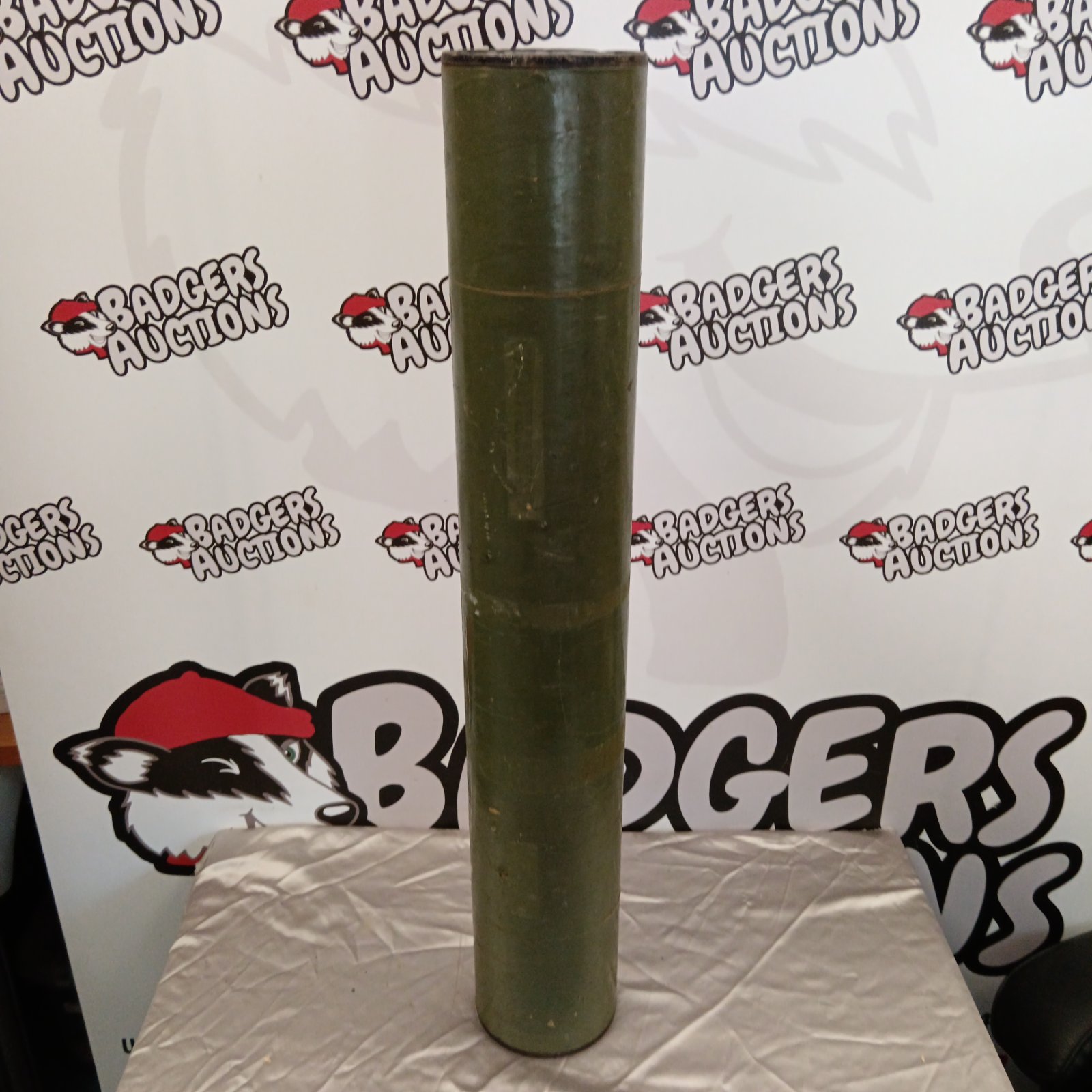 Vintage 1989 military cannon shell case, weathered metal.
