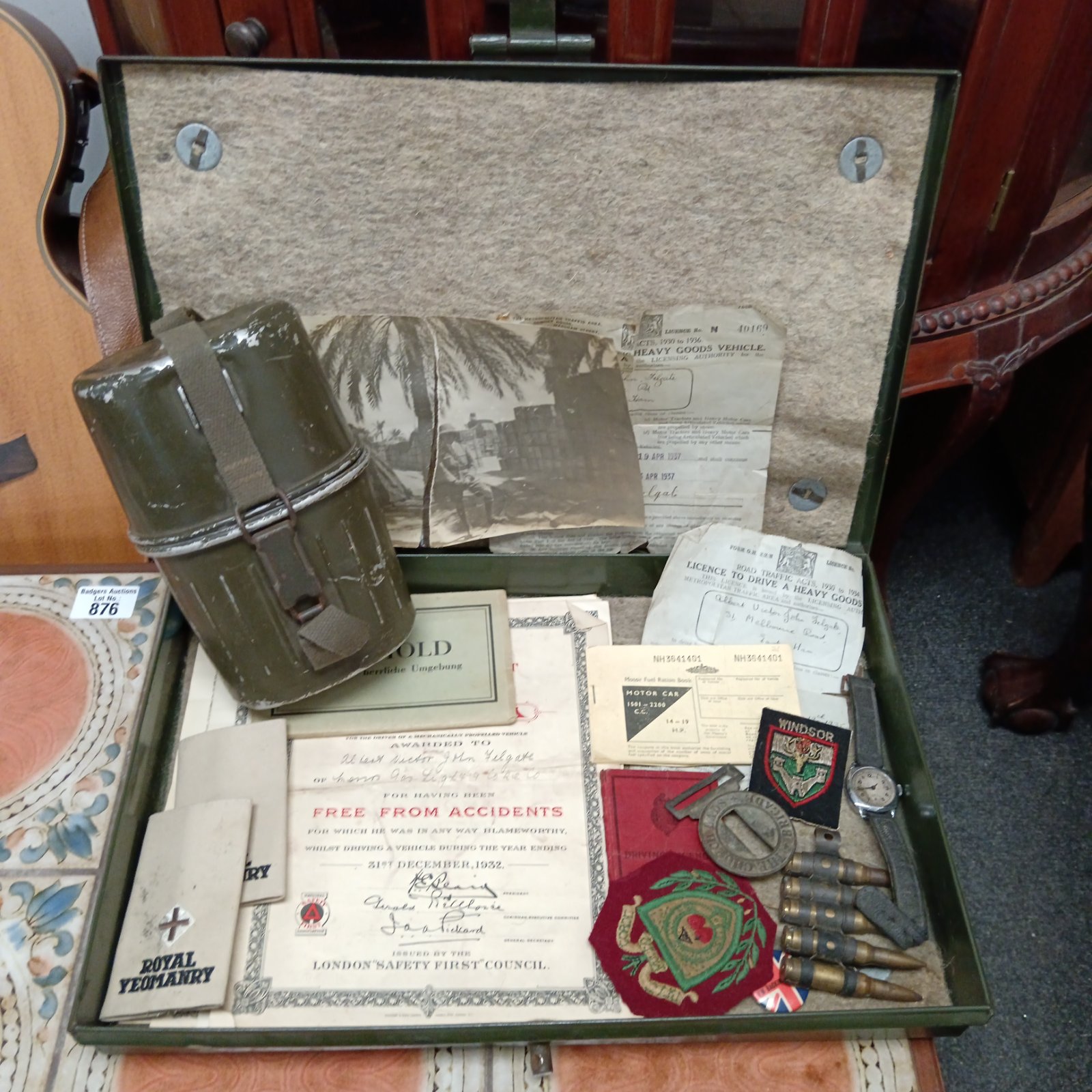 Vintage military ephemera collection in a metal tin.