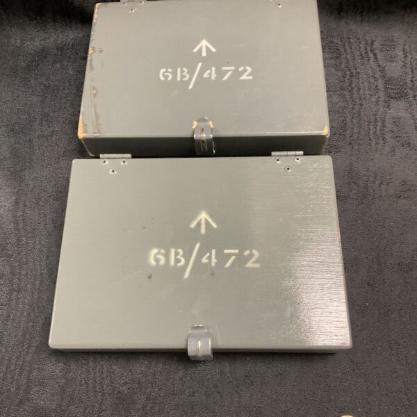 Vintage grey military navigator box, model GB/472, showing wear.