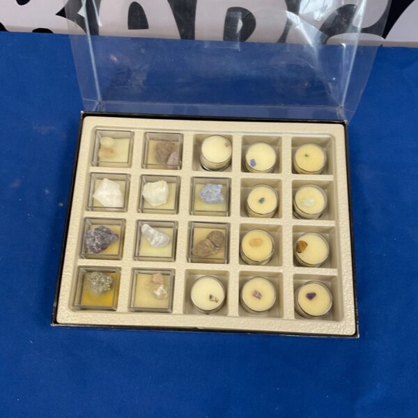 Mineral collection display case with various colourful stones.