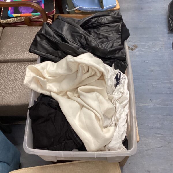 Crate filled with a mixed clothing lot including Adidas and Next items.