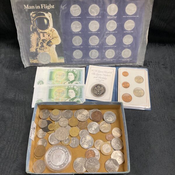 Mixed coin collection including a Man in Flight coin and £5 coin.