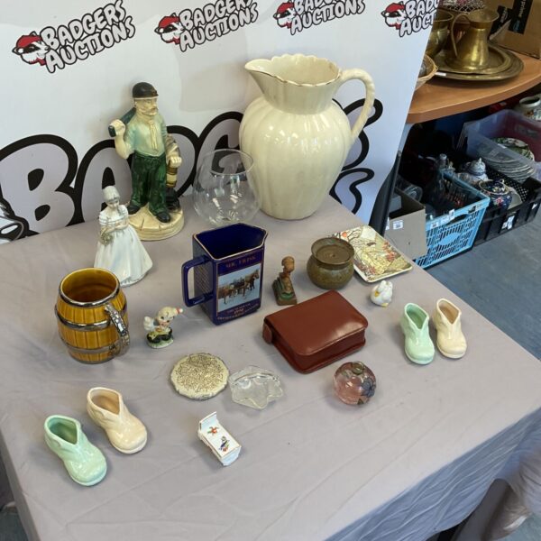 Mixed collectible lot featuring a vintage water jug and porcelain figurines.