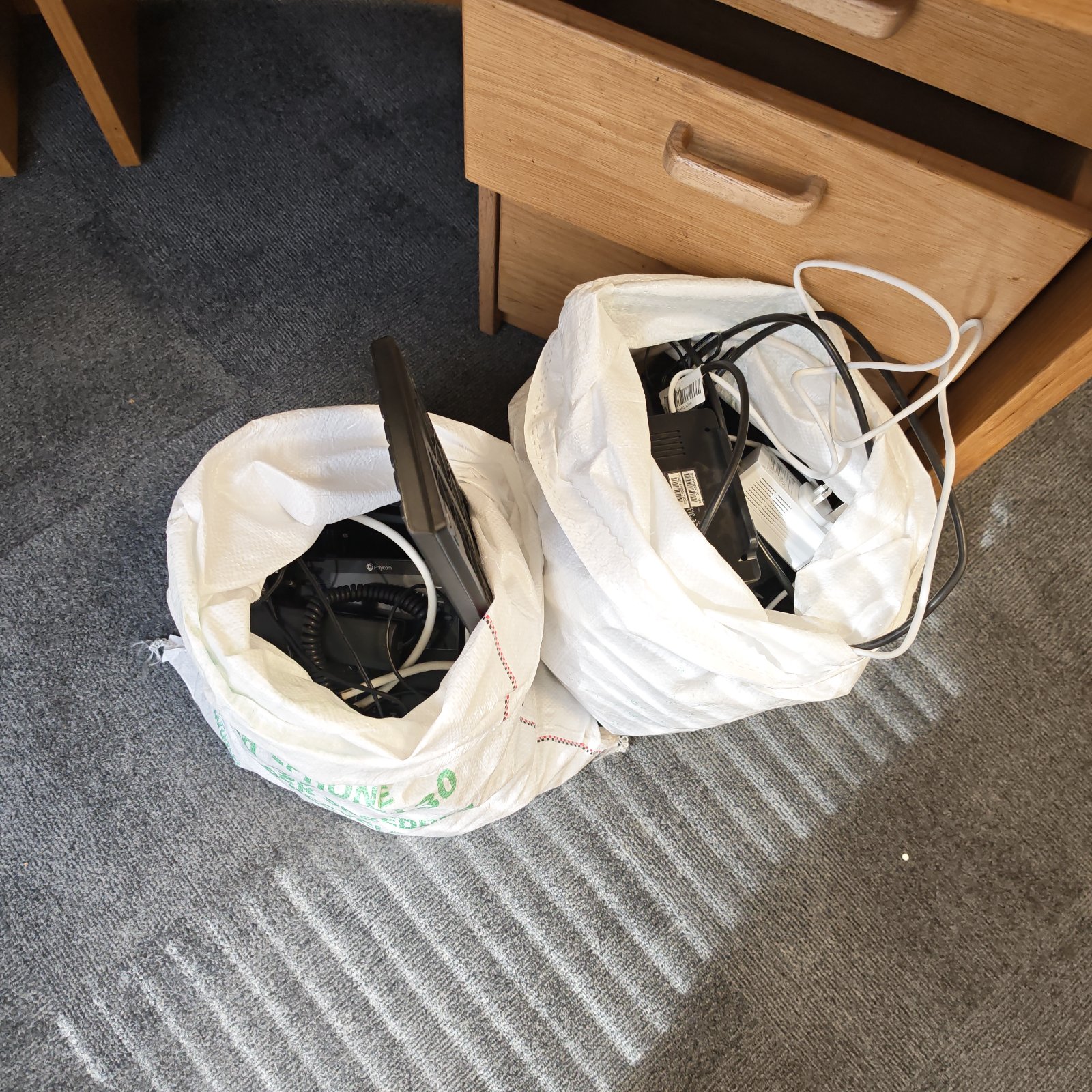 Mixed electronics lot featuring a Polycom office phone and cabling.