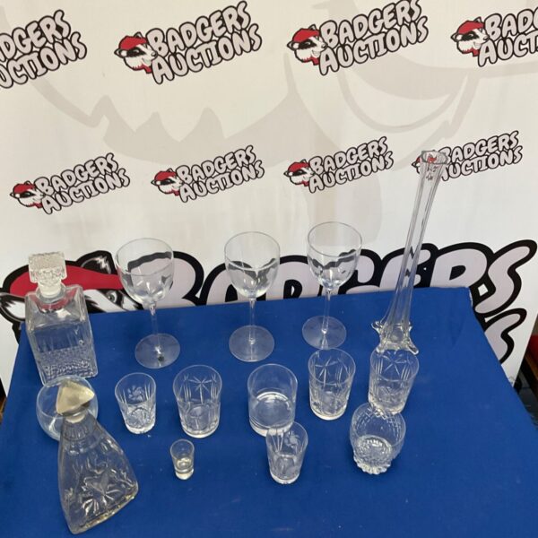 Mixed glassware lot featuring decanters and a tall vase for collectors.