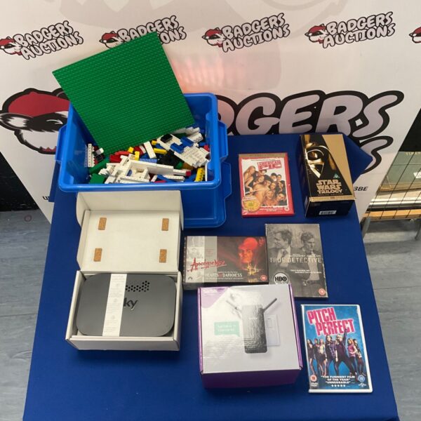 Mixed lot of Lego, Sky Q box, and DVDs for sale.