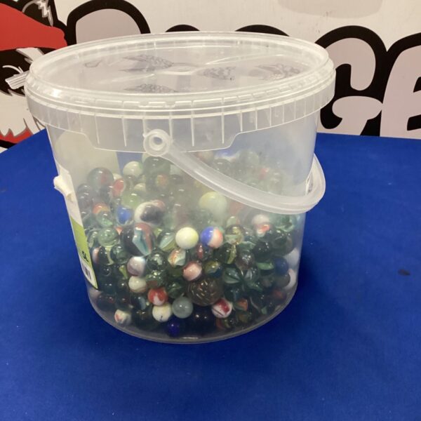 Tub filled with a colourful collection of mixed glass marbles.