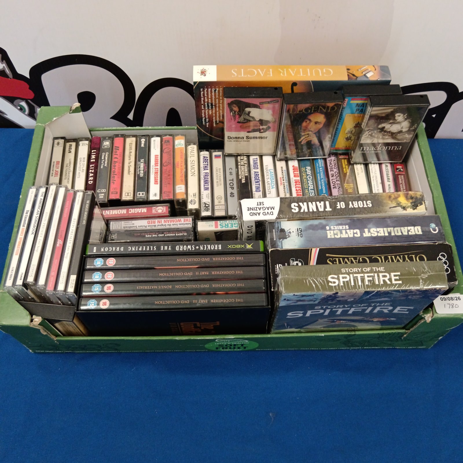 Mixed media lot of cassette tapes, CDs, and DVDs for collectors.