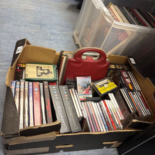 Mixed media lot including DVDs, CDs, vinyl and cassettes in a crate.