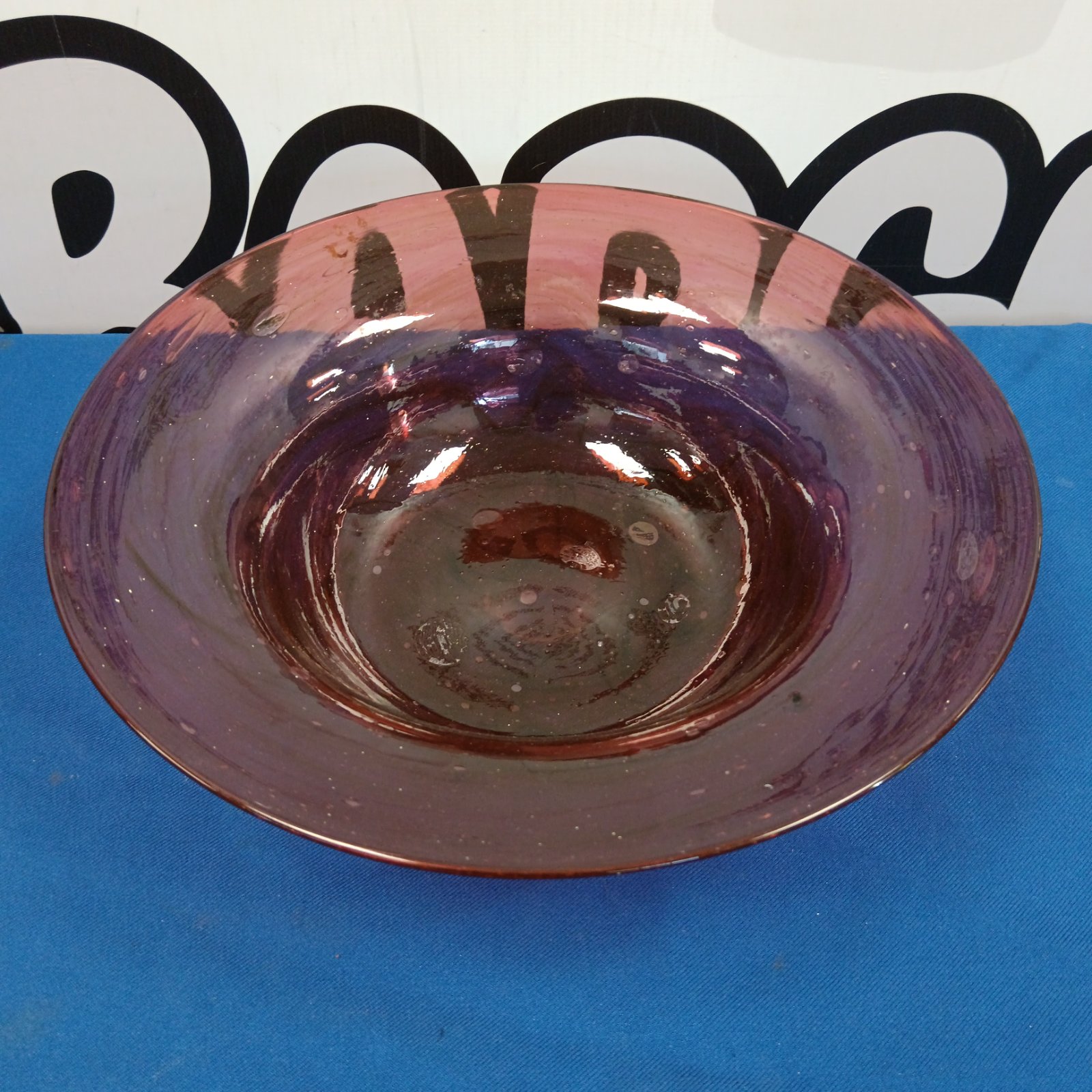 Vintage Monart glass bowl with purple swirls and flecks.