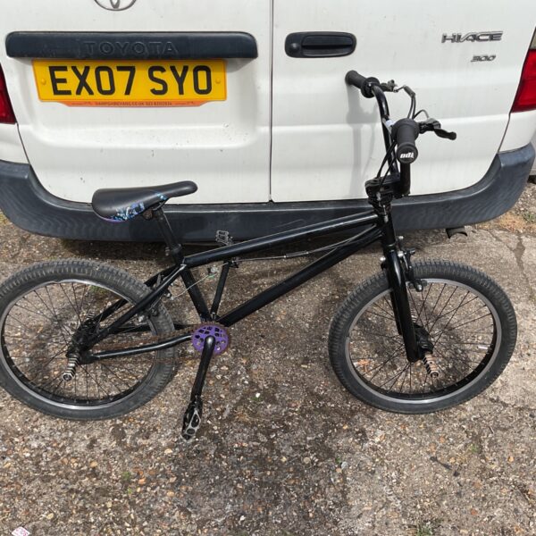 Side view of a vintage Mongoose BMX bike in used condition.