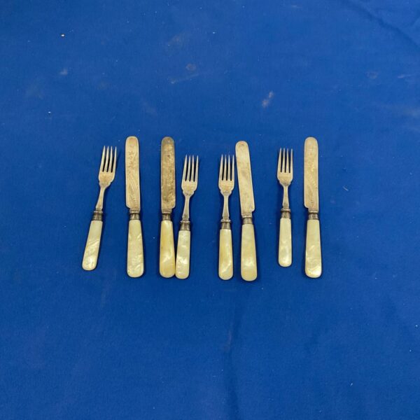 Vintage mother of pearl knife and fork set with silver plated blades.