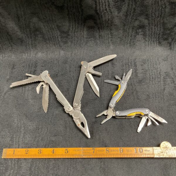Stainless steel multi tool lot with folding blades and tools.