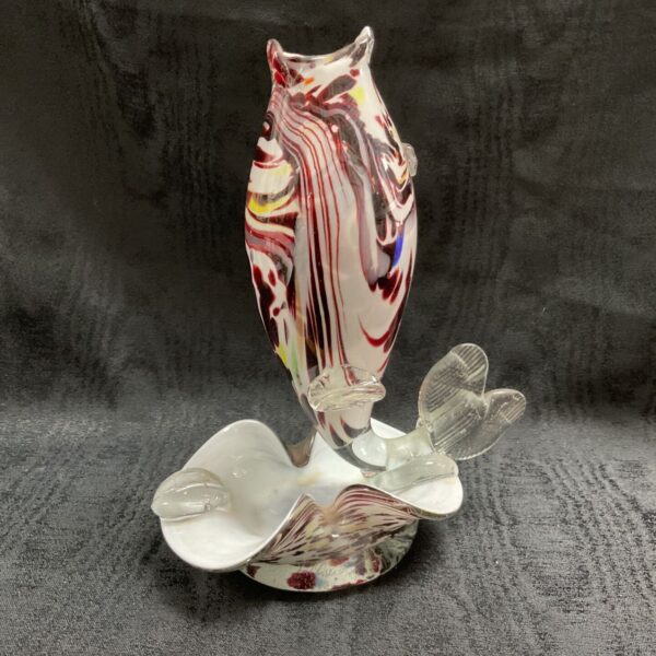 Vibrant Murano glass fish sculpture with red and white swirls.