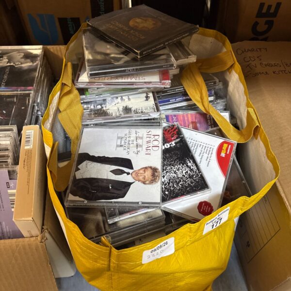 Mixed lot of music CDs in a yellow bag.