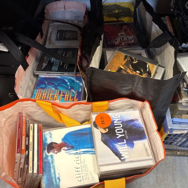 Mixed music CD lot in a plastic bag.