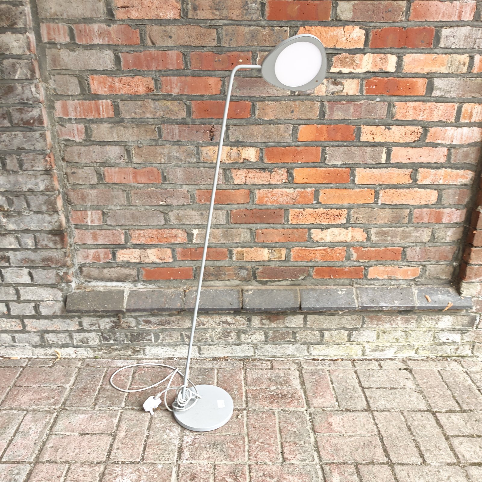 Modern Muuto Leaf floor lamp with a curved lampshade.