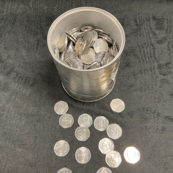 Tub of vintage national transport tokens and coins.
