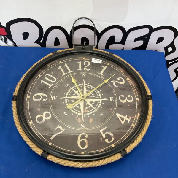Vintage nautical wall clock with rope detail.
