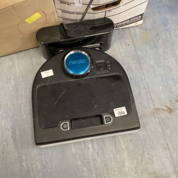 Neato robotic vacuum cleaner on a cardboard box.