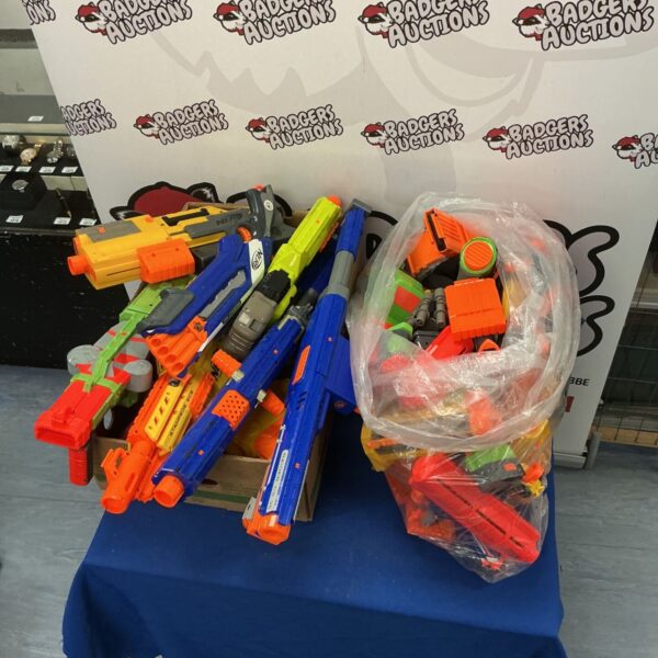 Large collection of Nerf guns and attachments for foam dart battles.