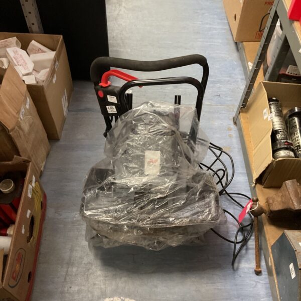 Netta 1500w electric garden tiller covered in plastic.