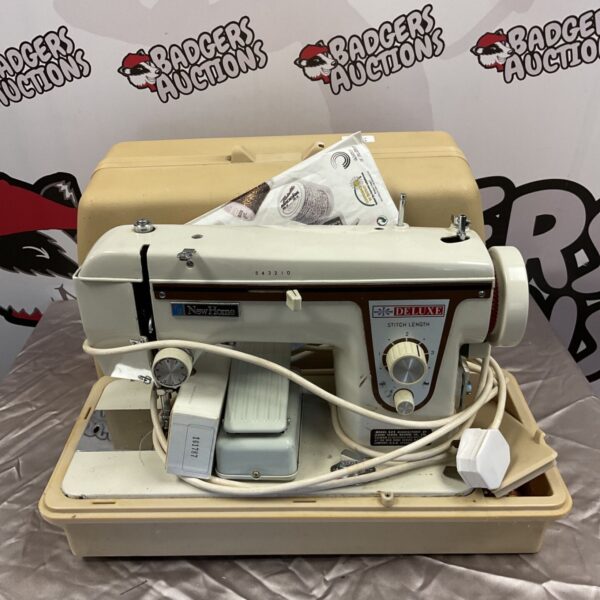 Vintage New Home Deluxe sewing machine model 525 in cream.