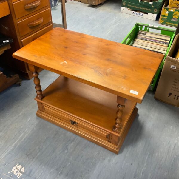 Vintage oak coffee table with drawer on wheels, ideal for farmhouse decor.