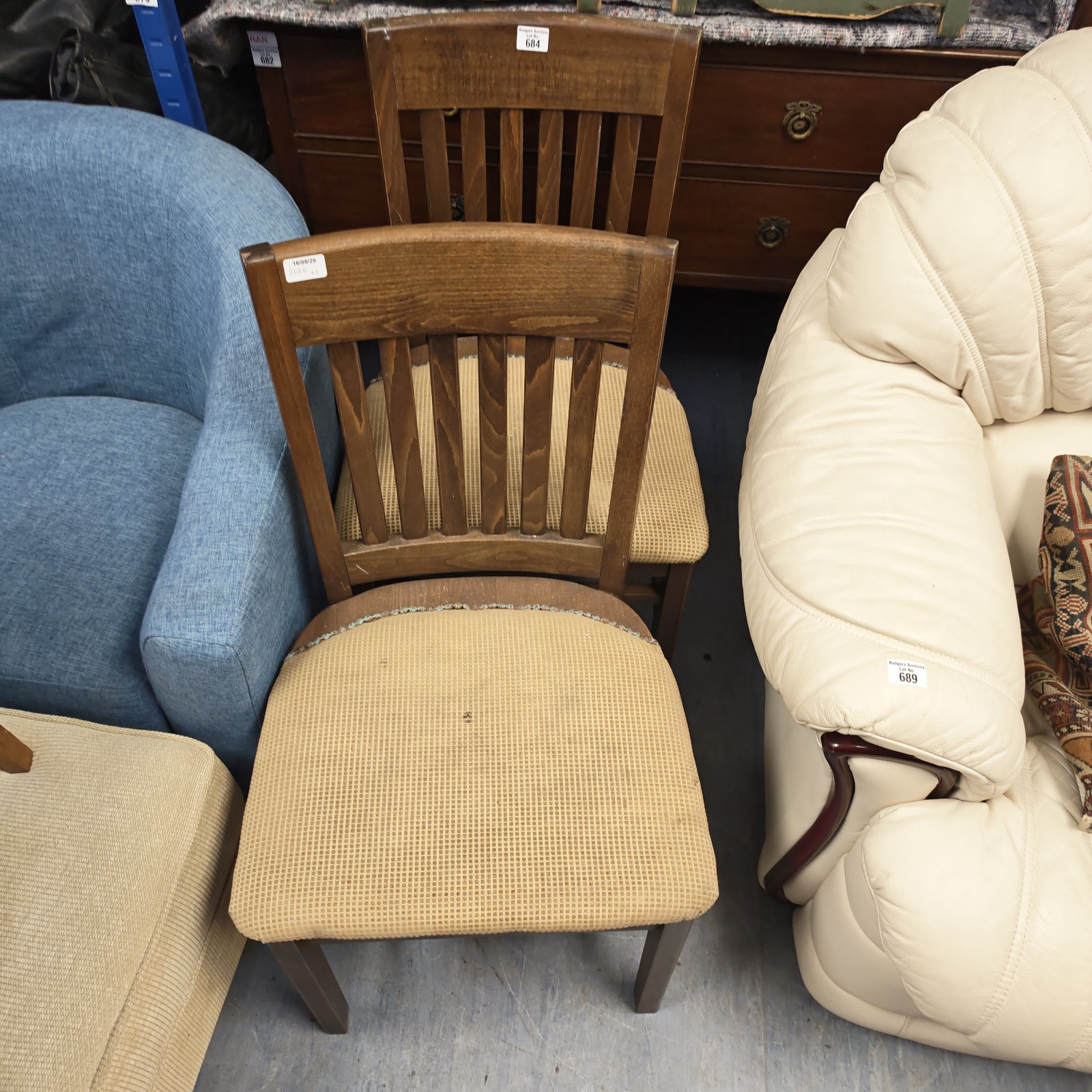 Vintage pair of oak dining chairs with upholstered seats.