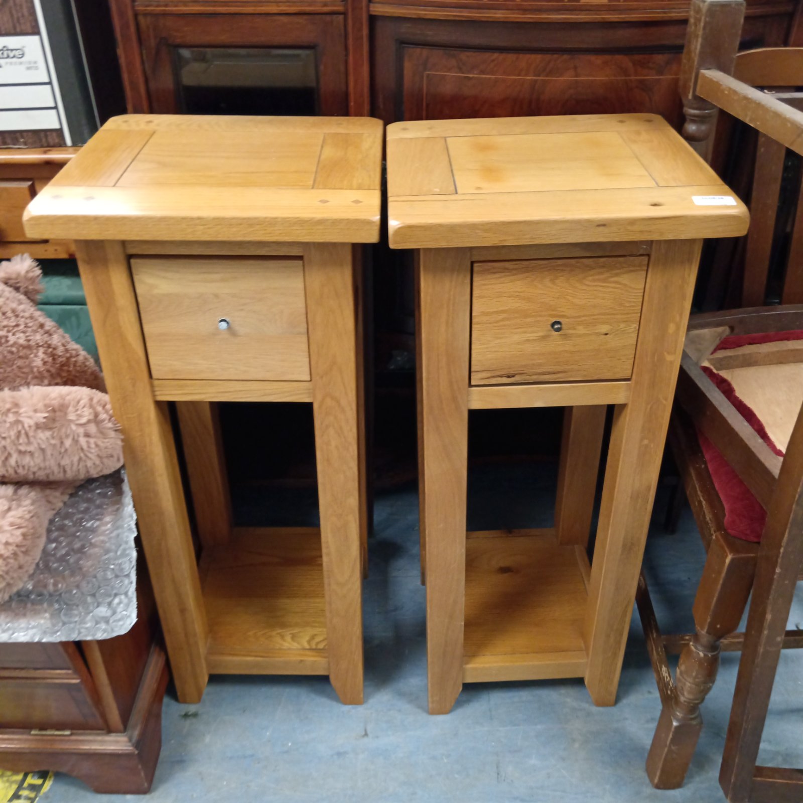 Pair of solid oak lamp tables with a drawer.