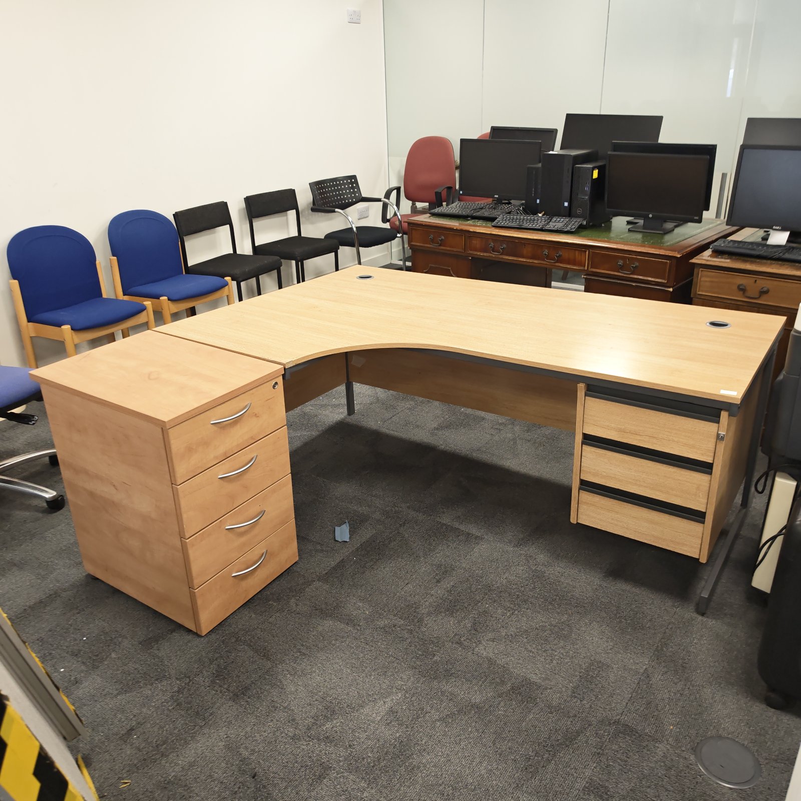 Wooden office corner desk with four drawer cabinet unit.