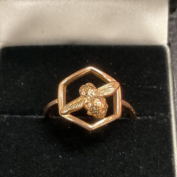 Olivia Burton bee ring in a display case.
