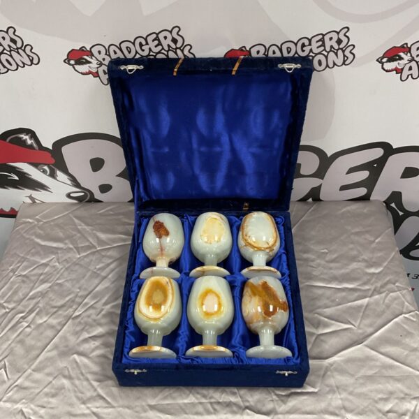Set of six white and amber onyx marble goblets in a blue velvet case.