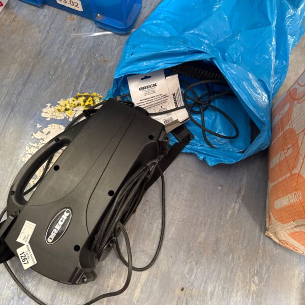 Blue Oreck handheld vacuum cleaner for portable cleaning.