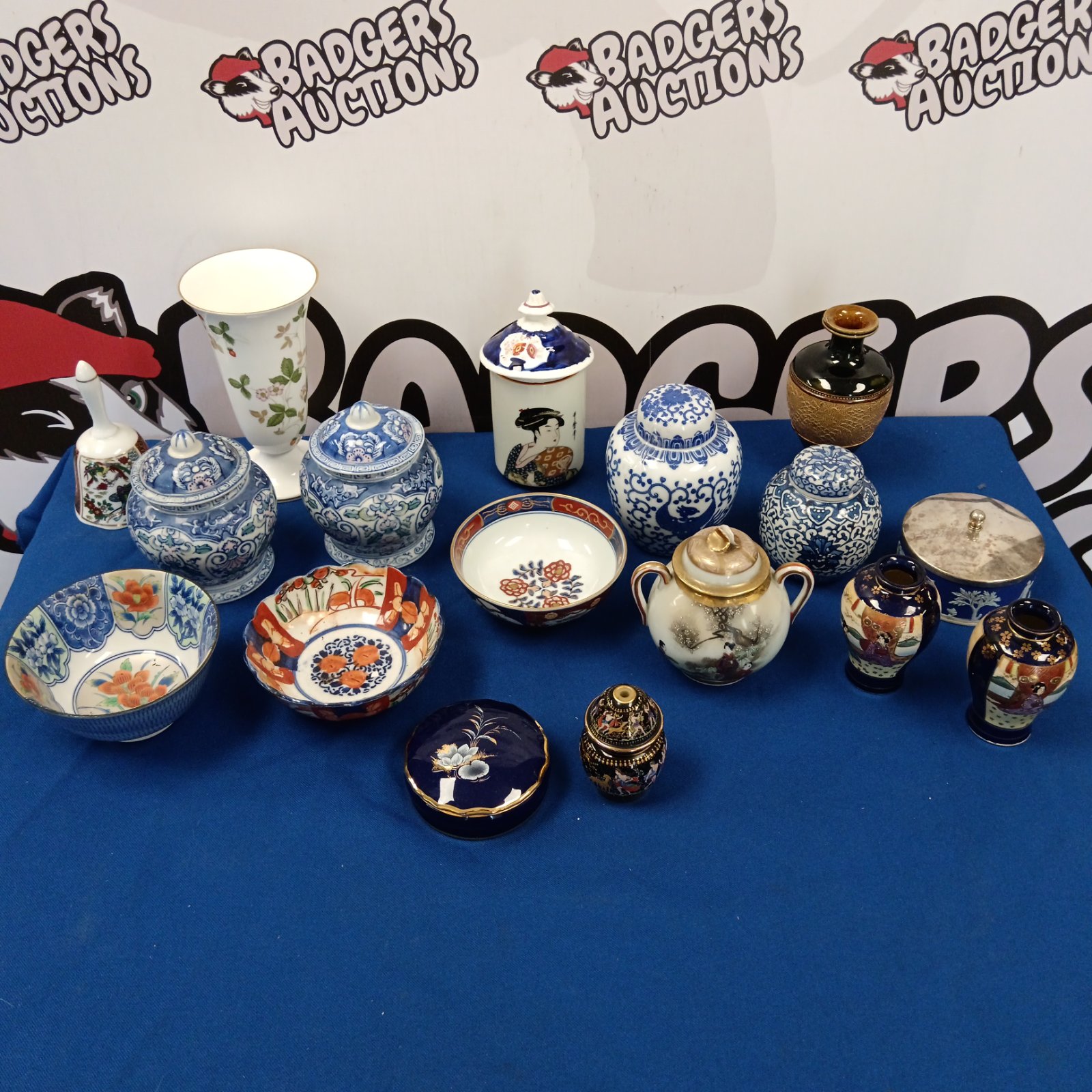 Collection of antique oriental ginger jars and vases on display.