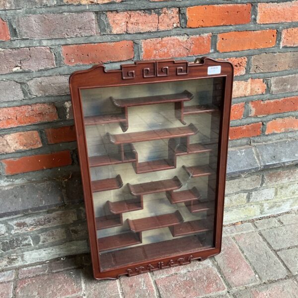 Oriental wooden and glass wall display cabinet with lock.