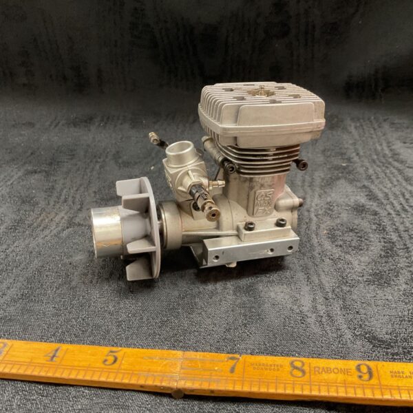 Front view of vintage OS Max model aircraft engine.