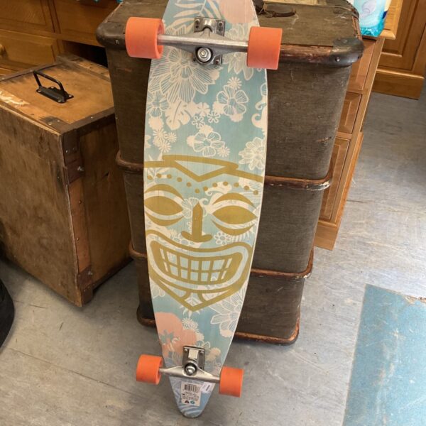 Vintage Pacific Coast longboard with a tiki mask design.
