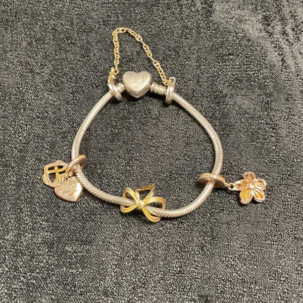 Vintage Pandora charm bracelet with silver charms.