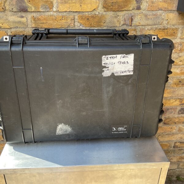 Black Pelican 1600 flight case with labels, showing exterior wear.