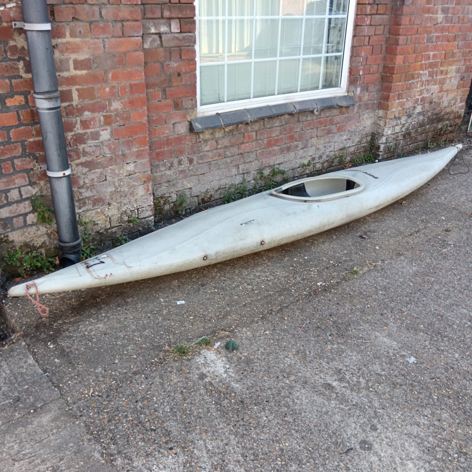 Used Perception kayak in a garden setting.