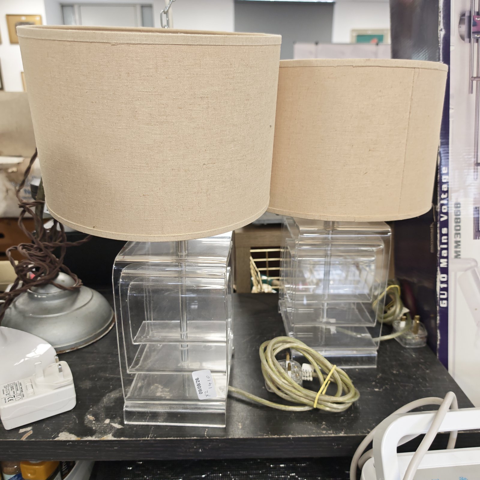 Pair of clear perspex table lamps with a 1970s aesthetic.