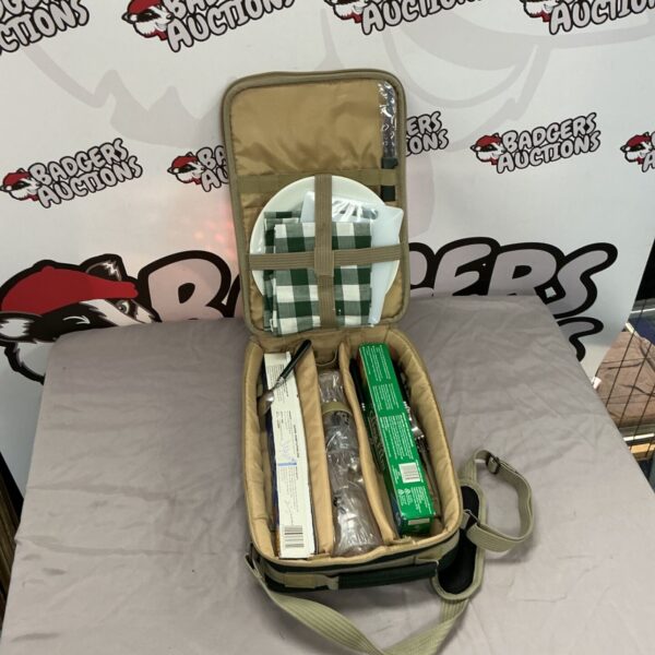 Open picnic basket showing contents and green plaid lining.