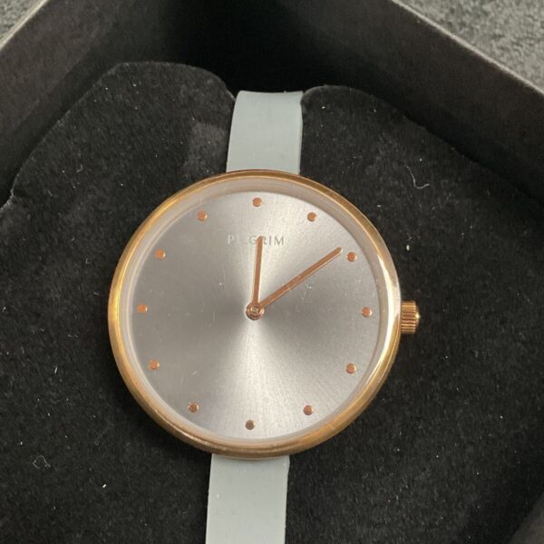 Pilgrim ladies wristwatch with rose gold case and grey strap.