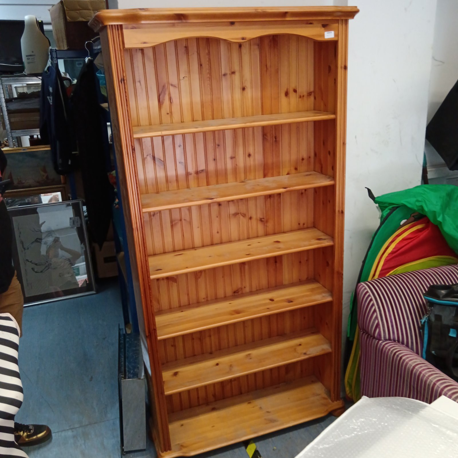 Vintage pine bookcase with six tiers for books and storage.